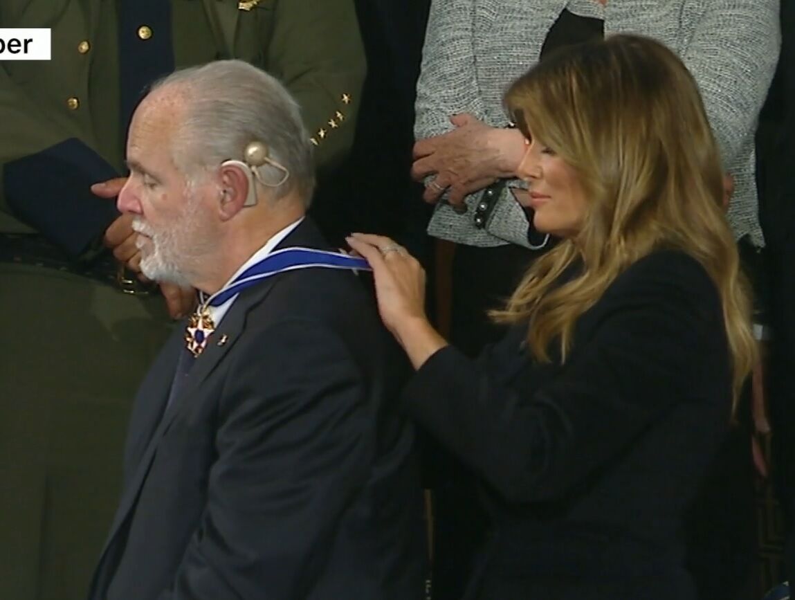 Melania Trump putting the Medal around Rush Limbaugh's neck.