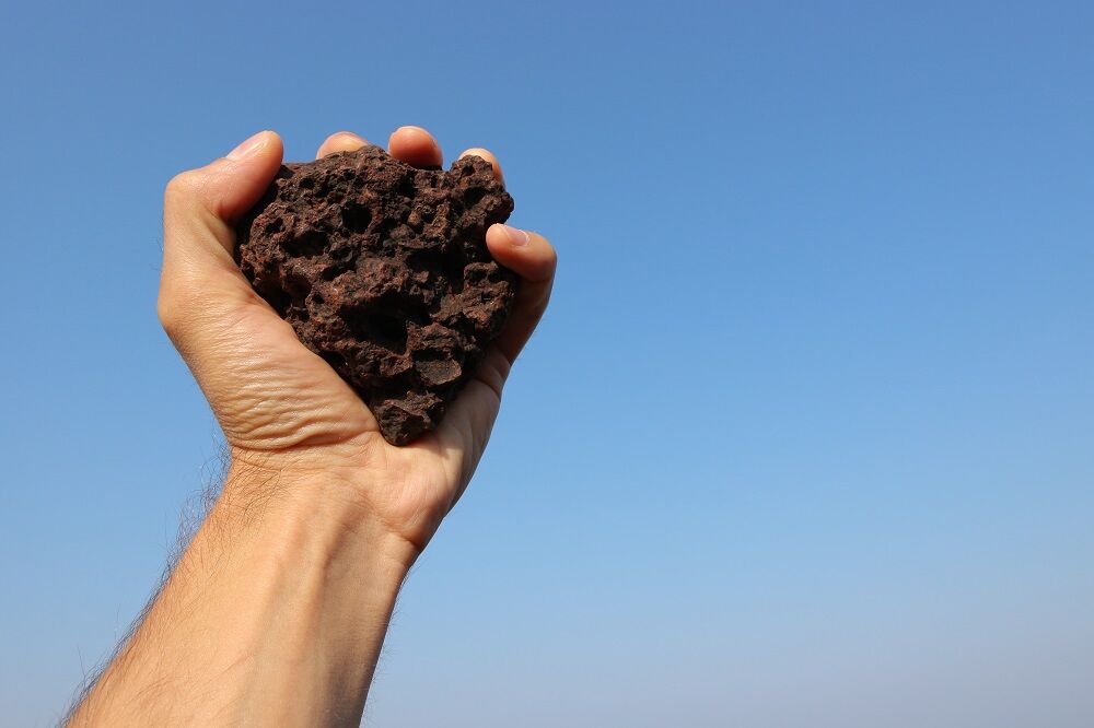 A hand holding a stone