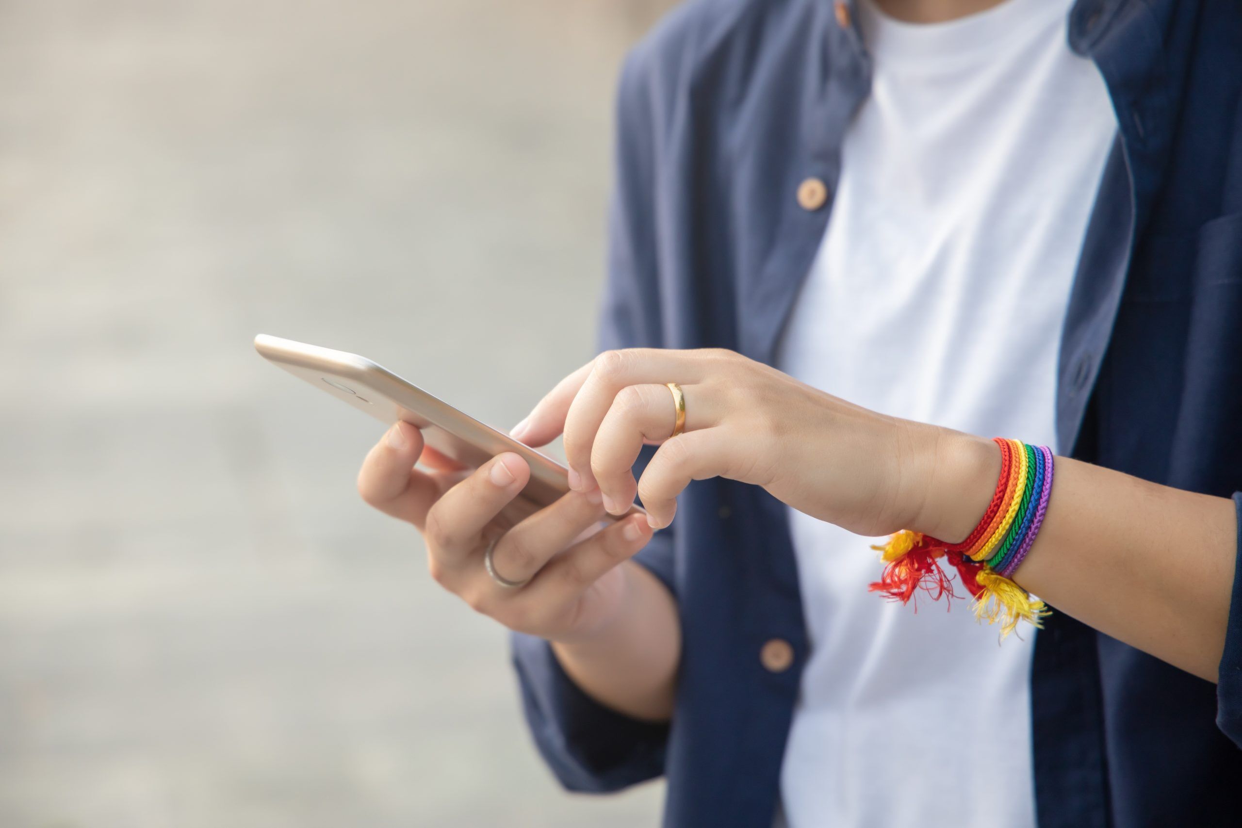 modern LGBT woman with ribbon symbol using smartphone