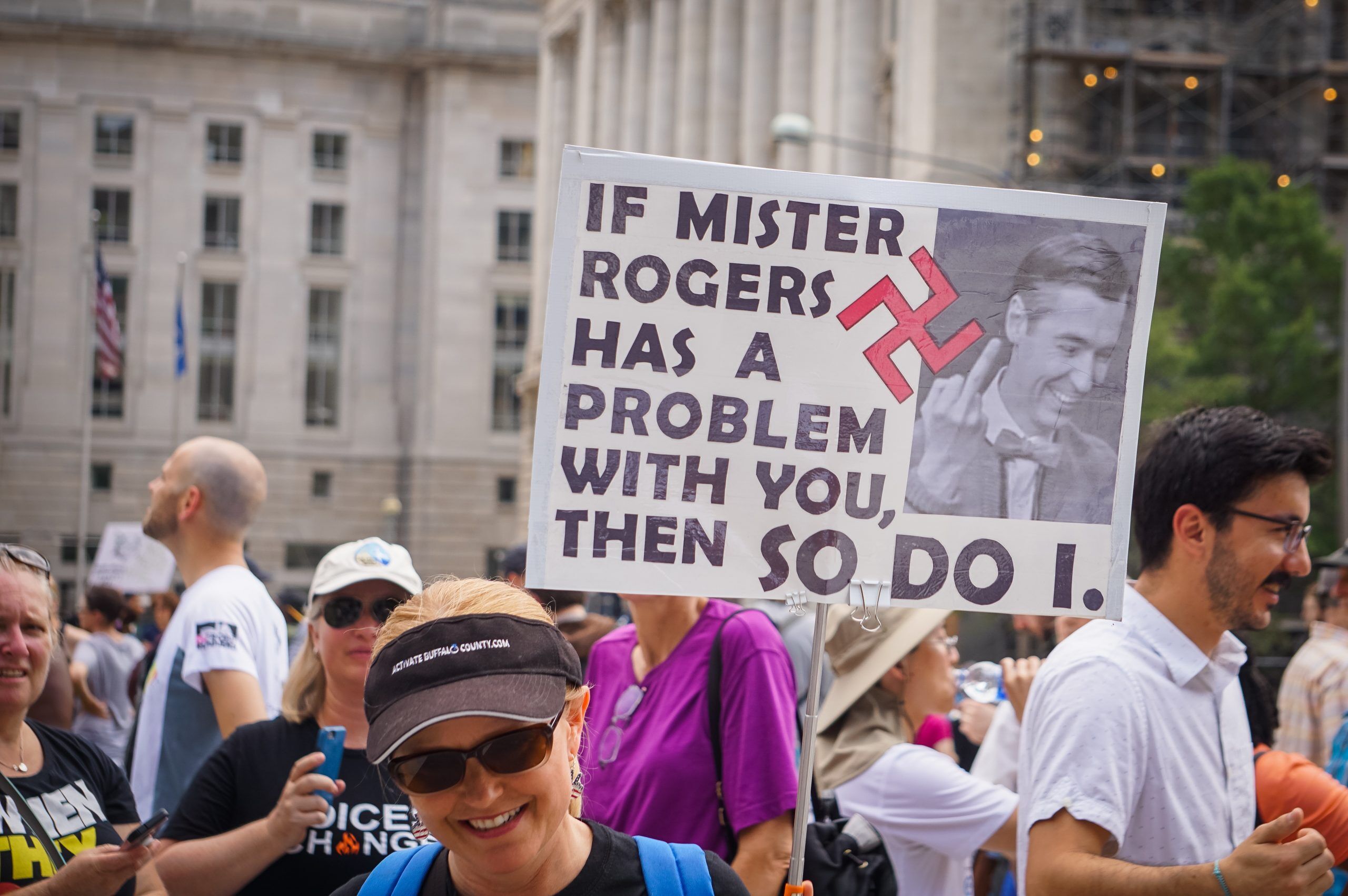 AUGUST 13, 2018: An activist in DC holds a protest sign about Mr. Rogers at the Unite the Right 2 counter protest