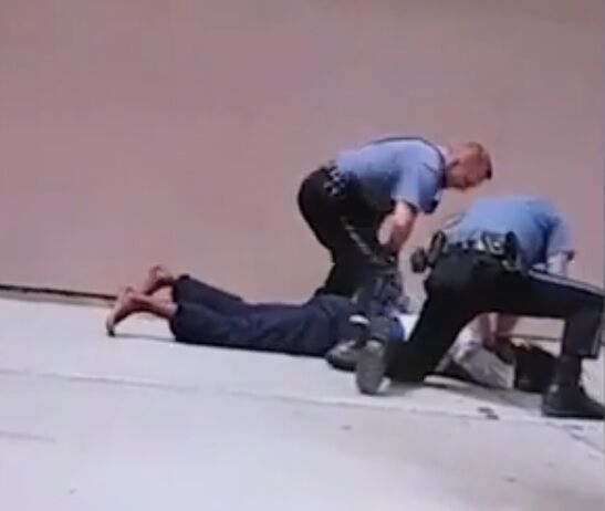 Officers appear to beat Hill's head against the pavement.