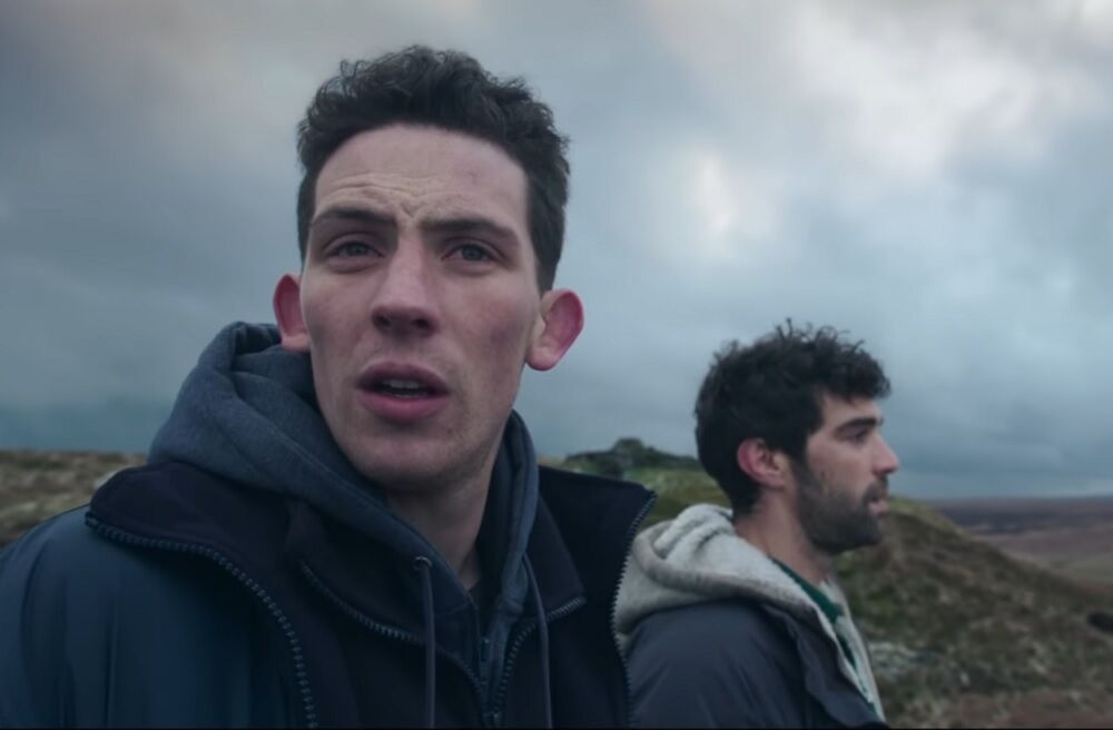 The two main characters of "God's Own Country" standing in a field