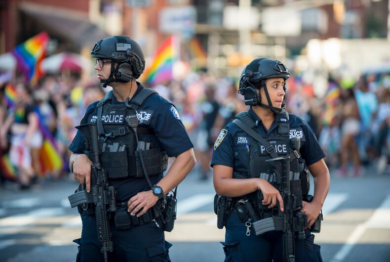 police-pride-parade JUNE 25, 2017: NYPD police officers stand with hands on their weapons, providing security on the sidelines of the annual Gay Pride parade as it passes through Greenwich Village.