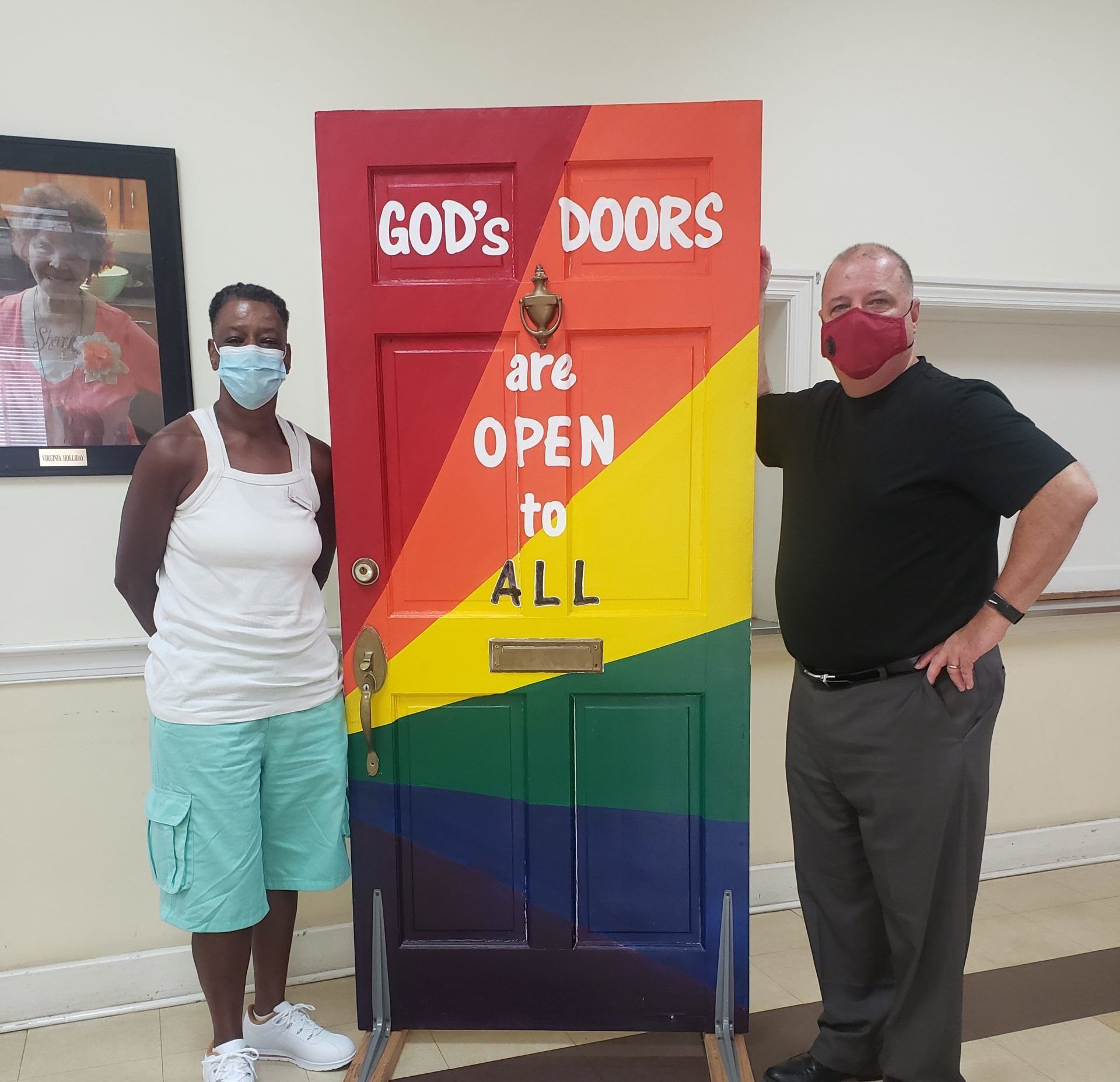 Rev. Billy Hester (right) and a congregant of Asbury Memorial Church, in front of the model of "God's Door" placed in the Church.