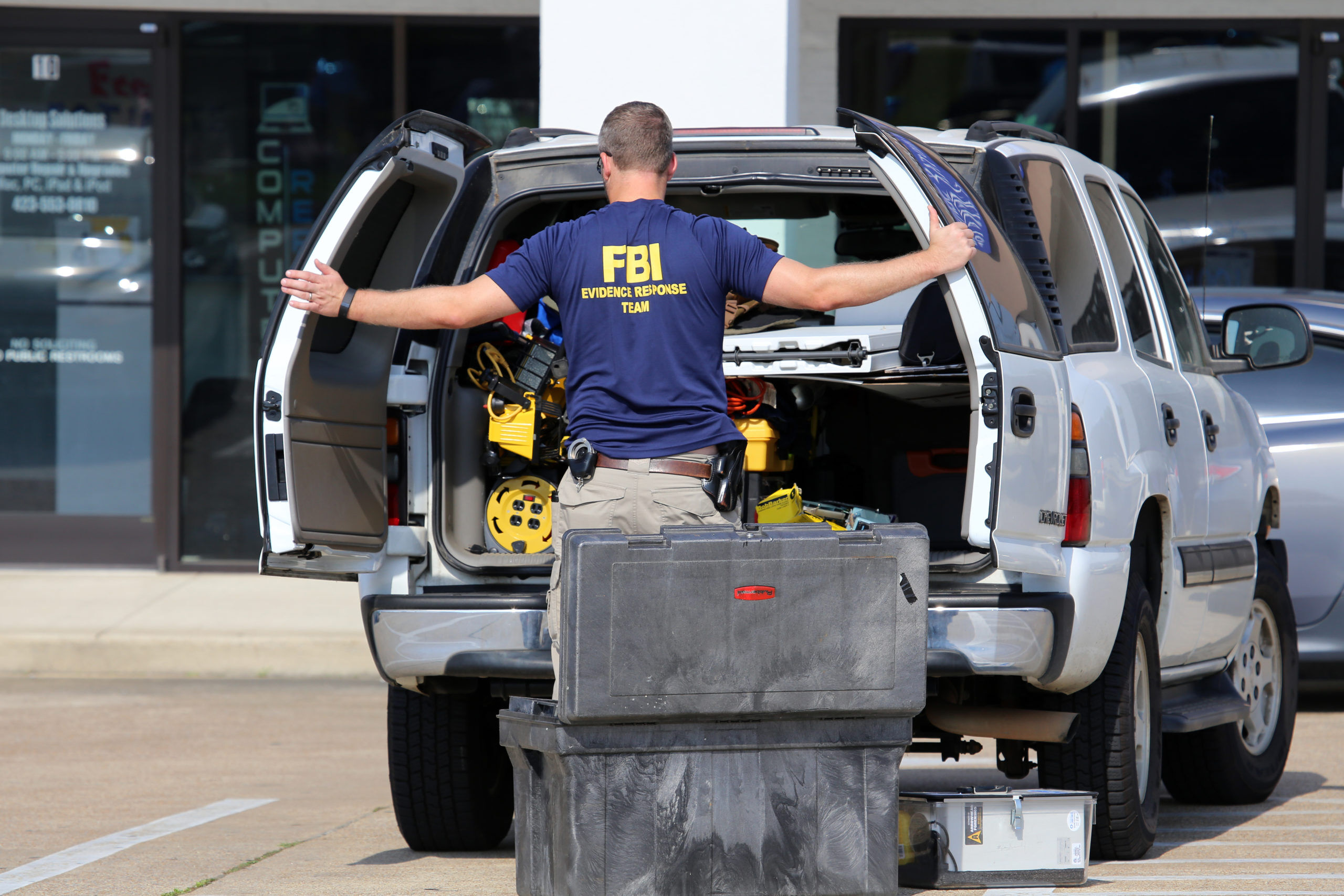An FBI agent gathers evidence at the Armed Forces Career Center in Chattanooga, TN on July 18, 2015. An attack on the center was carried out on July 16th, 2015.