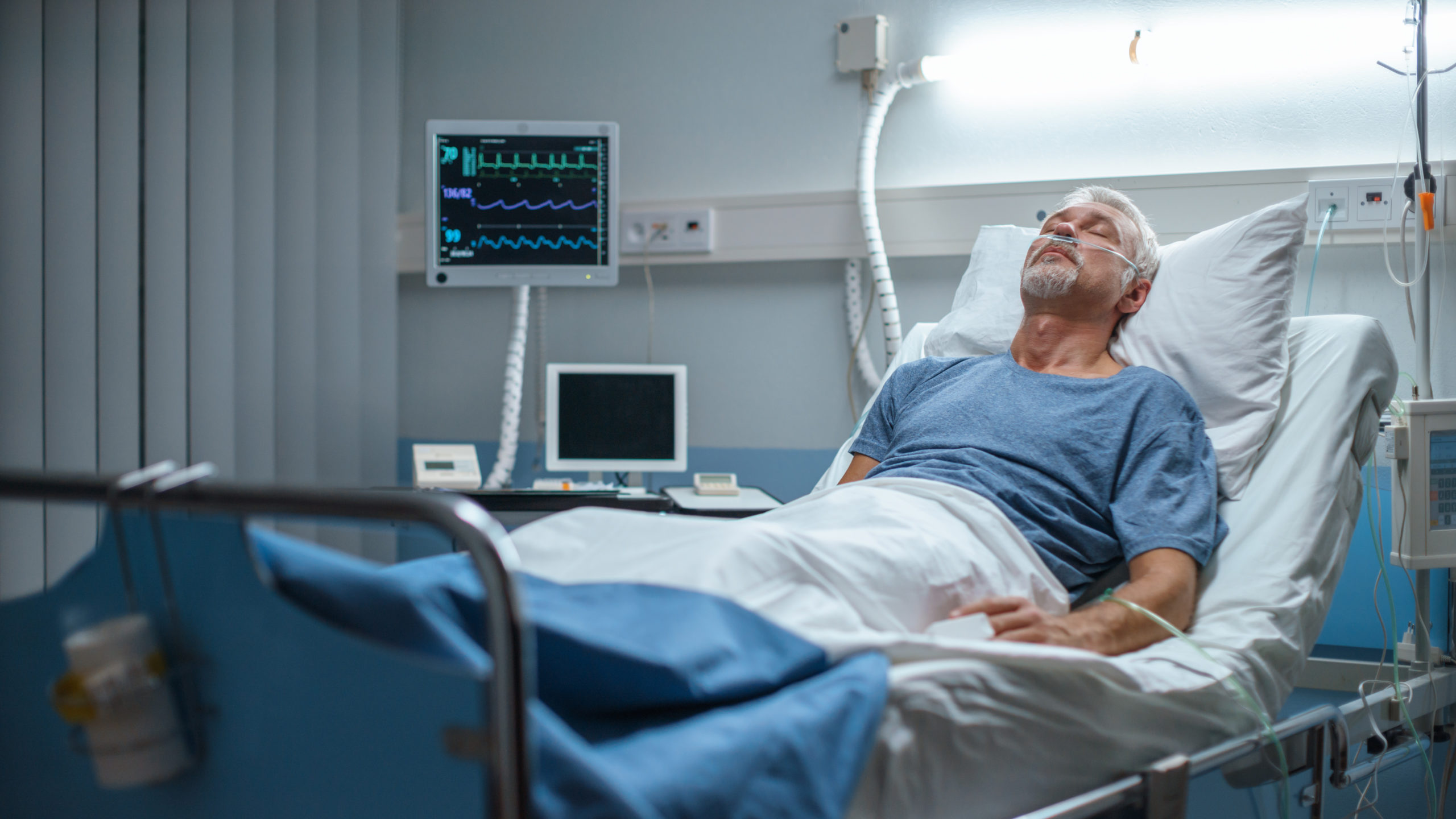 An old white man in a hospital bed. It's a stock photo.