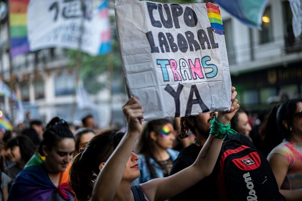 A sign in favor of a trans work quota at Buenos Aires Pride in 2019