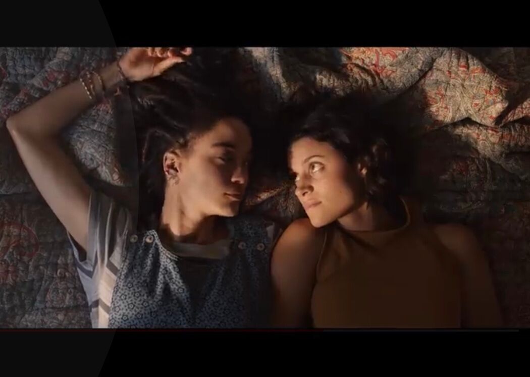 A lesbian couple sharing a look in a new Oreo ad in partnership with PFLAG.