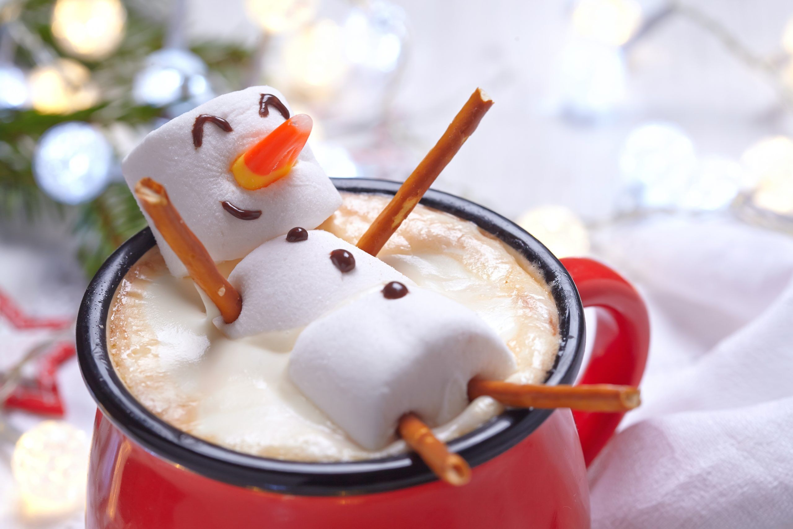 A marshmallow figure in hot cocoa and it looks happy