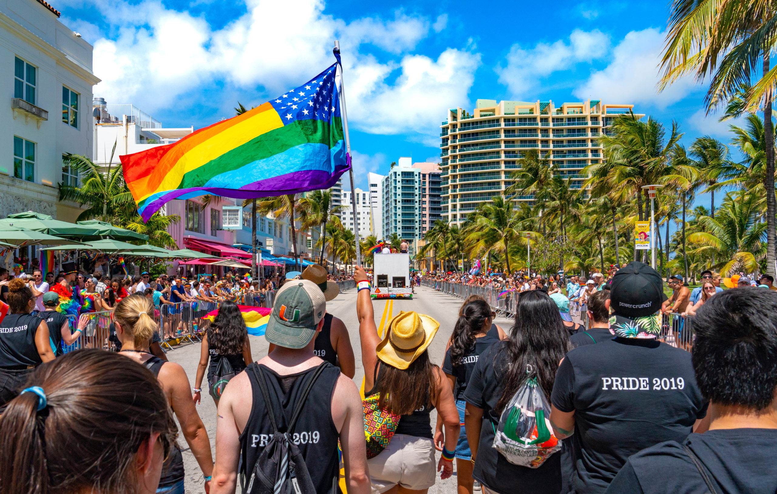 MIAMI, FLORIDA / UNITED STATES - APRIL 9, 2019: Pride Parade on Ocean Drive in Miami Beach. An American LGBTQ Pride flag is being waved.