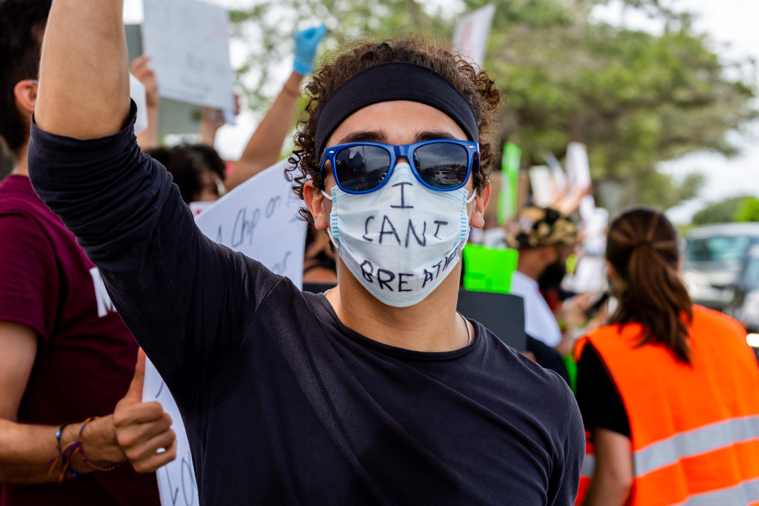 A man wearing sunglasses and a mask with the phrase "I Can't Breathe" in protest against the death in Minneapolis police custody of African-American man George Floyd at Coral Springs, Florida.