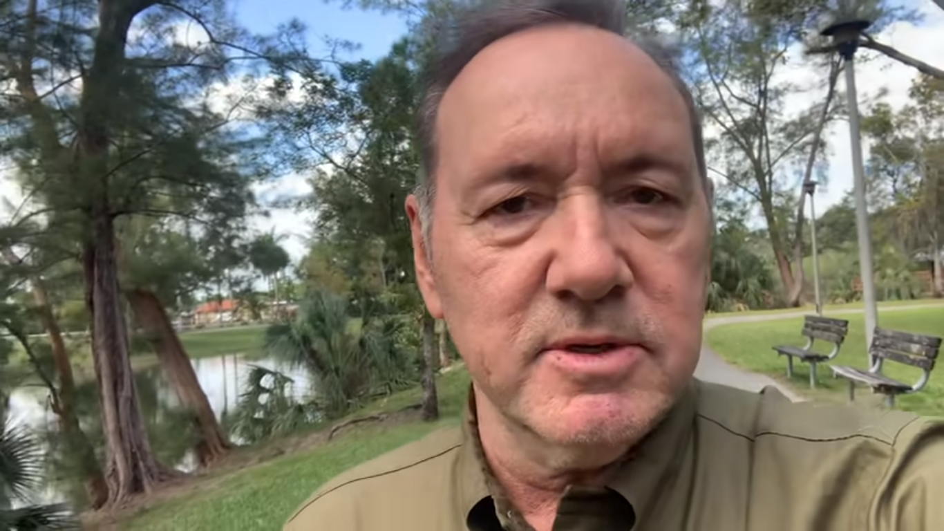 Kevin Spacey speaking to the camera in his "1-800-XMAS" video.