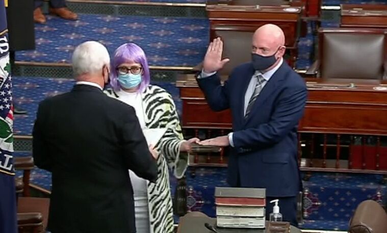 Vice President Mike Pence swears in Sen. Mark Kelly (D-AZ) as Sen. Kyrsten Sinema (D-AZ) holds the Bible.
