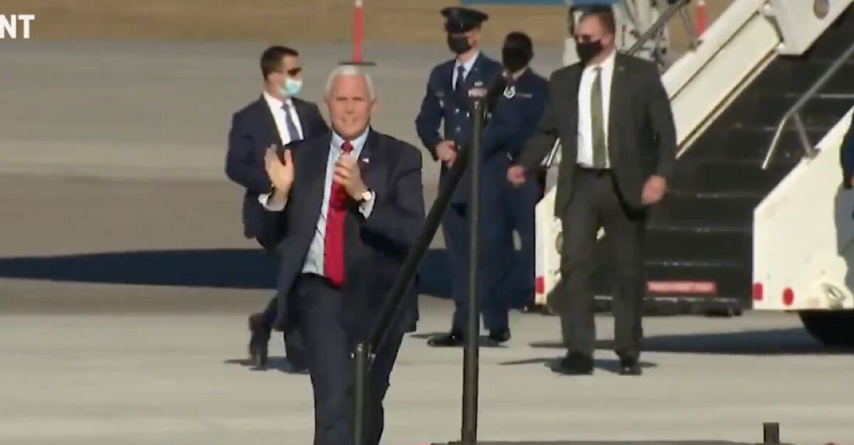 Vice President Mike Pence prances and claps on his way to the podium.
