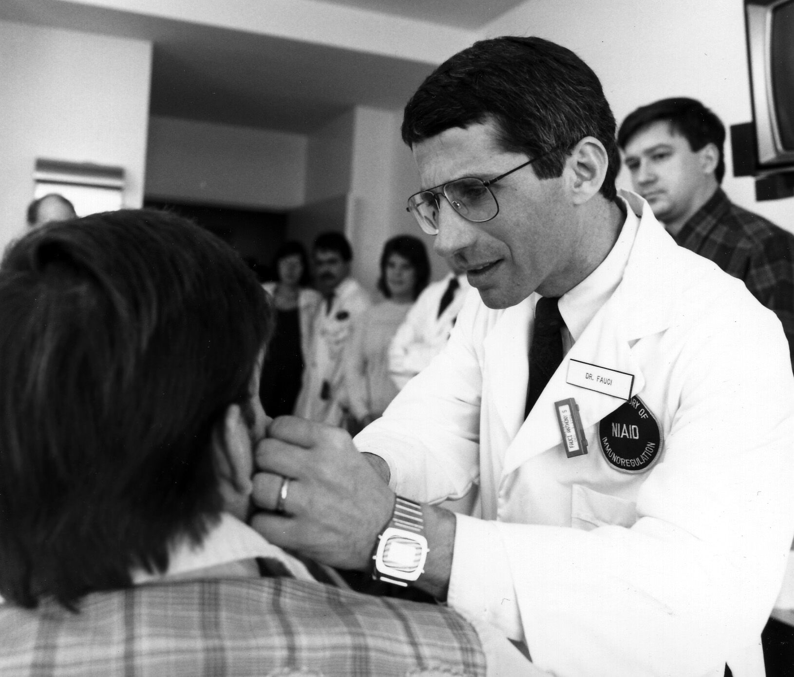 Dr. Anthony Fauci examining an early AIDS patient at NIH, 1987