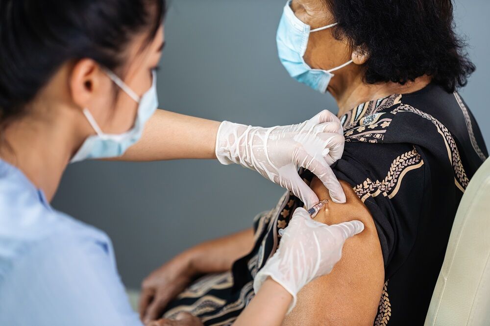 Doctor vaccinating a patient