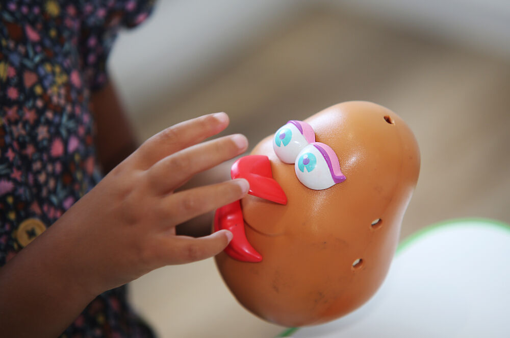 Coffs Harbour, NSW / Australia - Jan 2nd 2020: A child plays with a Mrs. Potato Head toy as part of a speech therapy session.