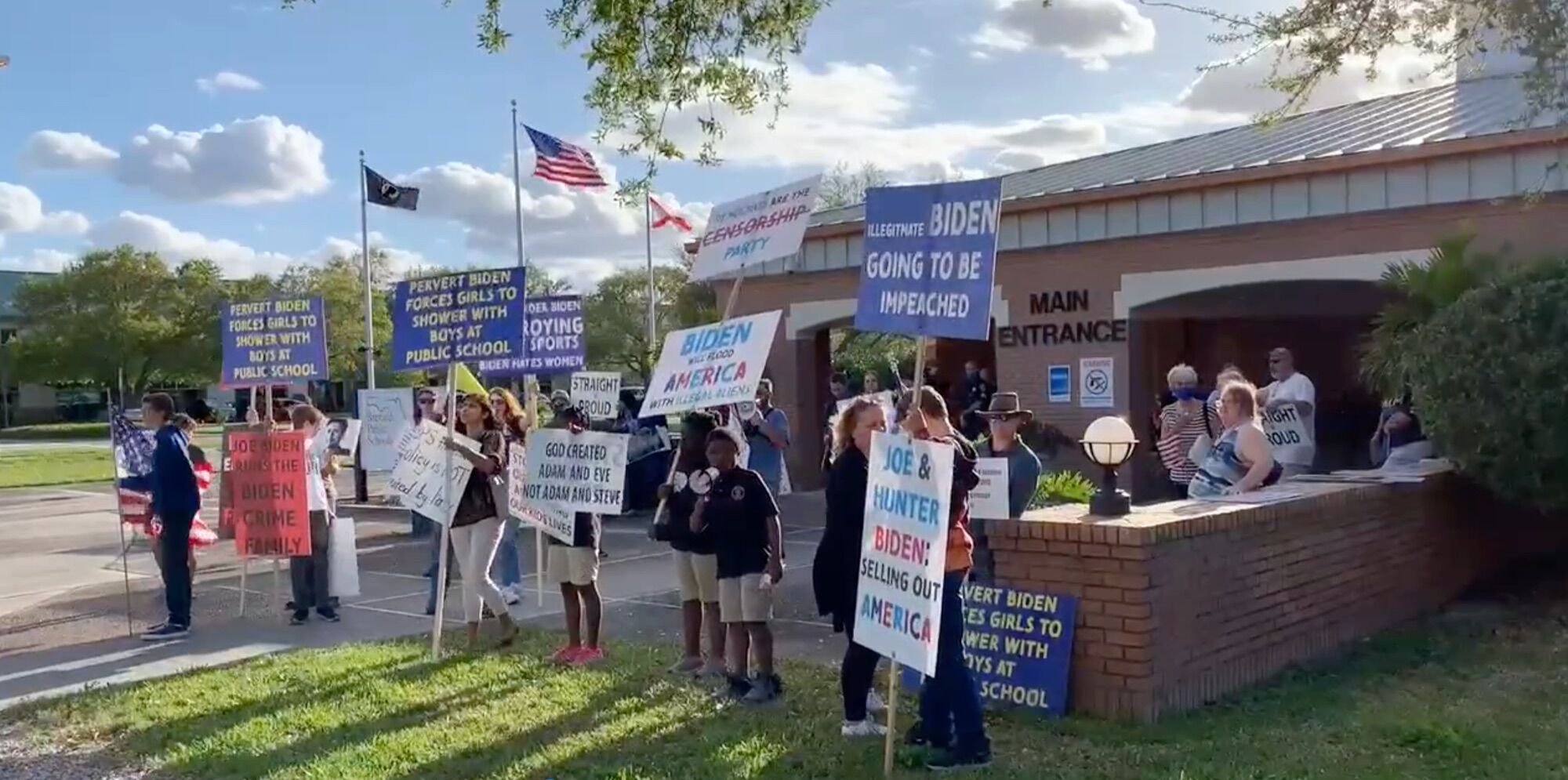 "Christian" Trump supporters protest outside a Florida school board meeting.