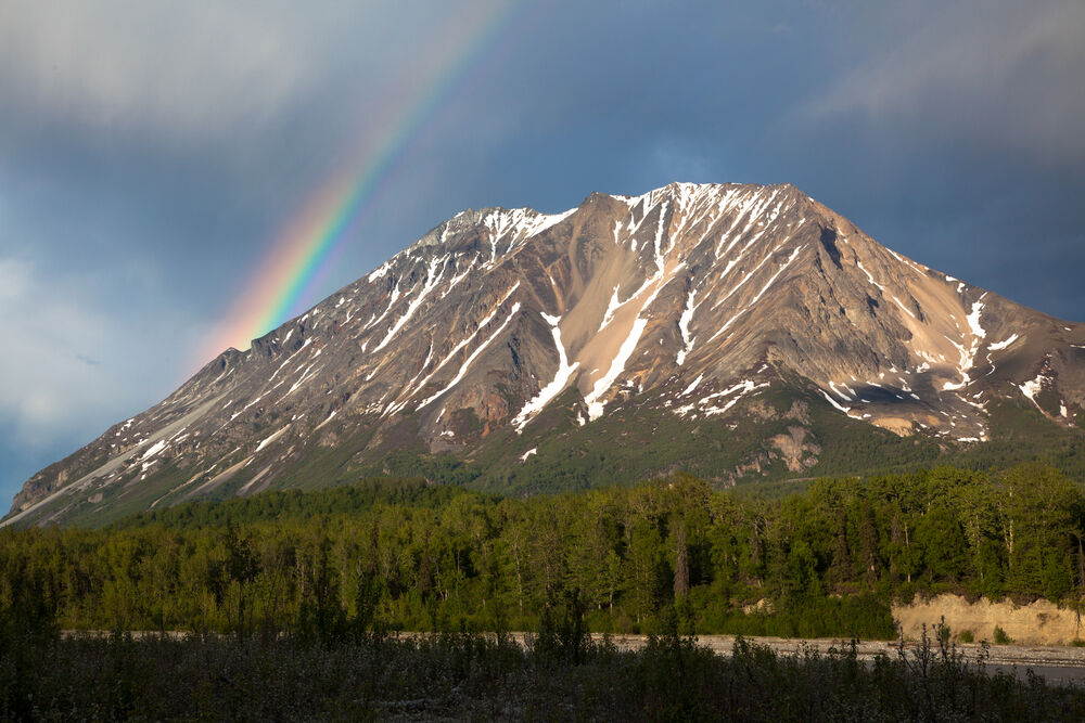 a rainbow and a mountain in alaska