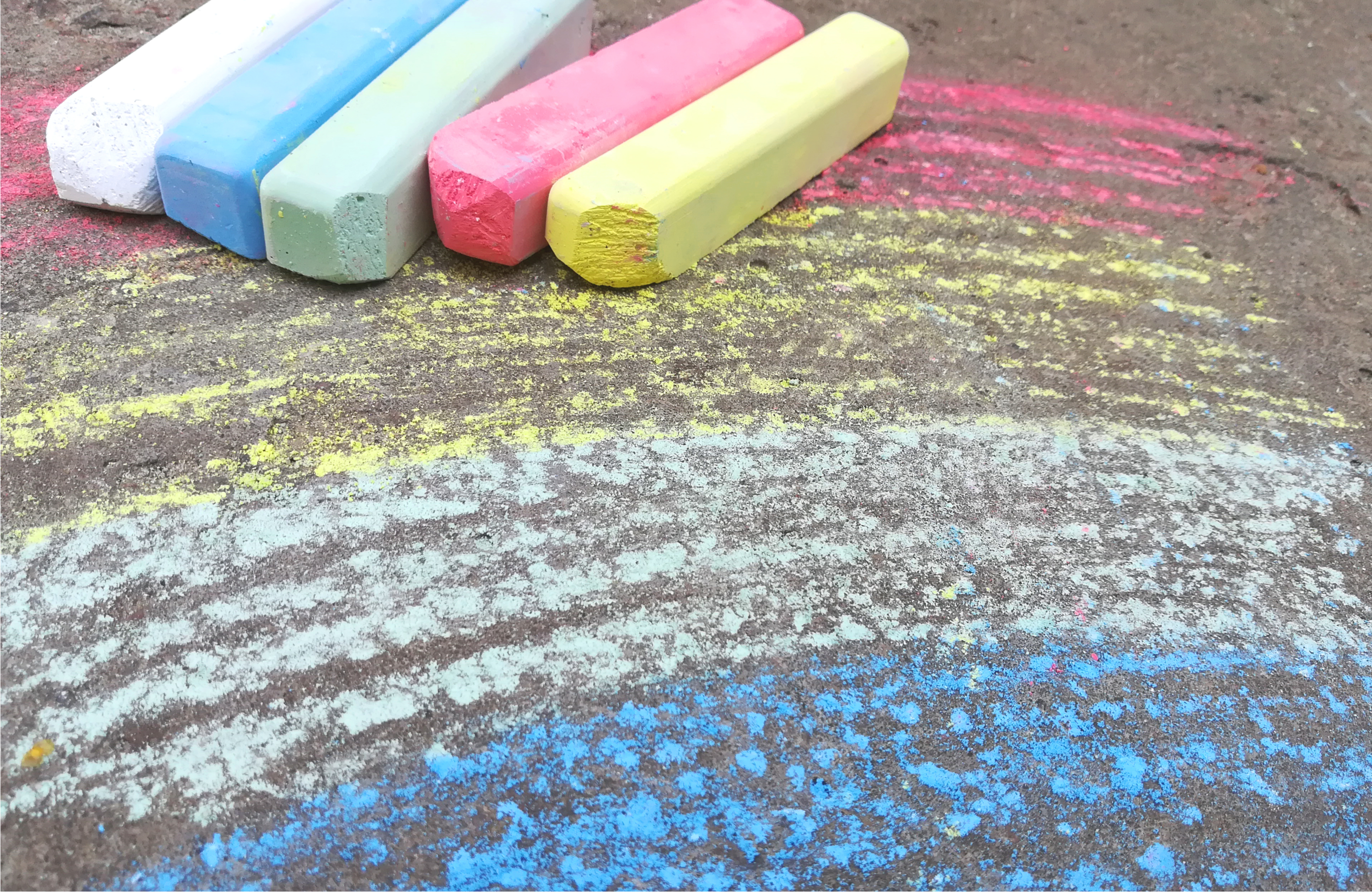 rainbow is drawn with chalk on the asphalt. colored summer background. children drawing, lgbt symbol