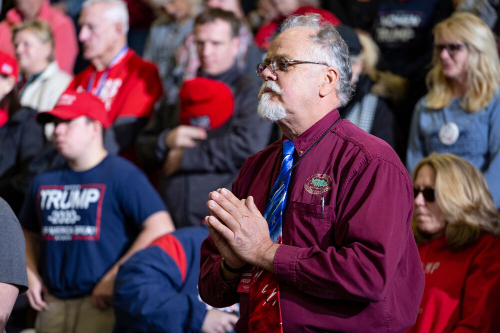 Wildwood, New Jersey - January 28, 2020: Man holds hands together in prayer during opening ceremonies at President Donald Trump's "Keep America Great" rally held at the Wildwoods Convention Center.