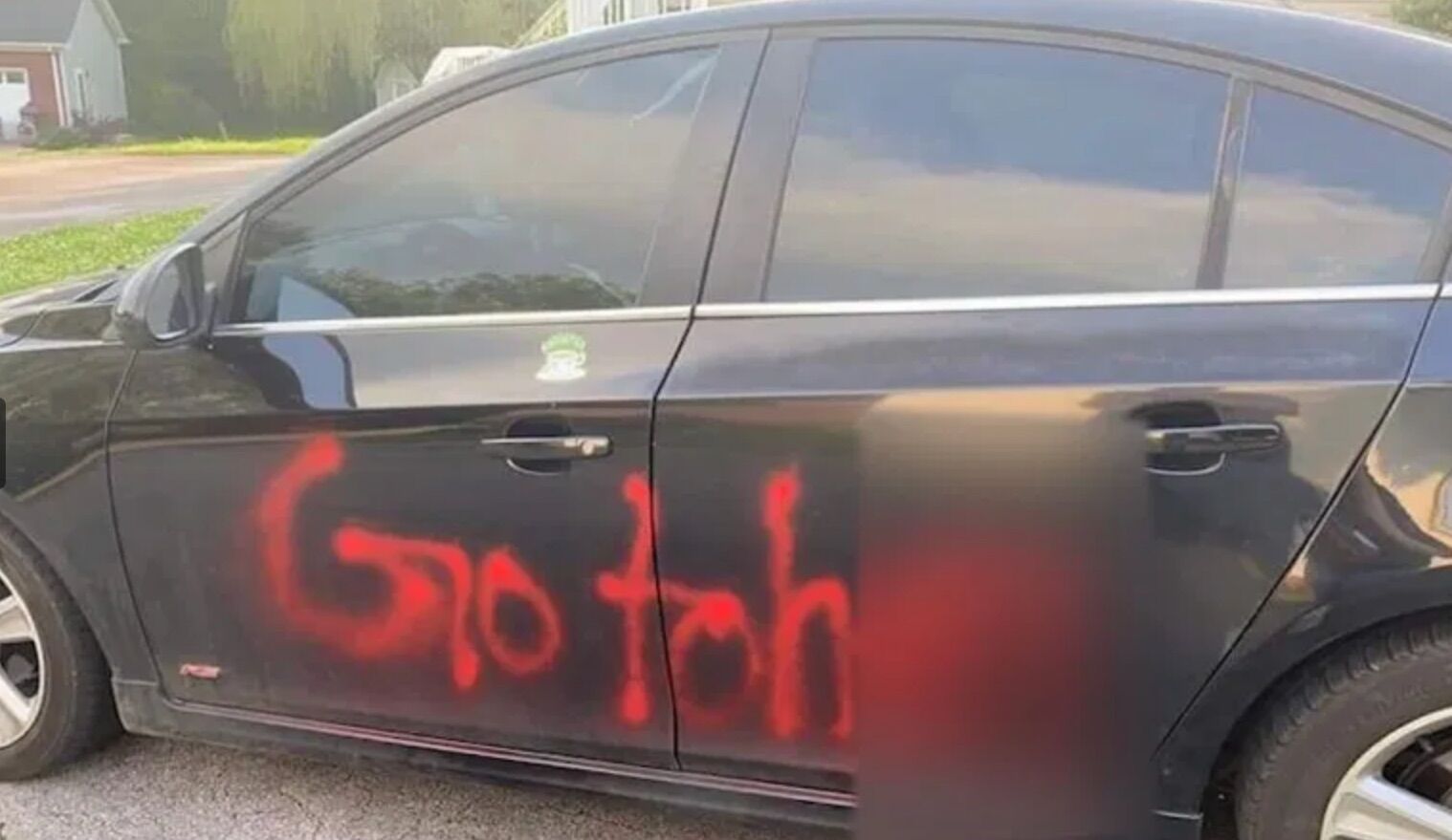 The vehicle was spray-painted with an anti-LGBTQ slur on the other side.