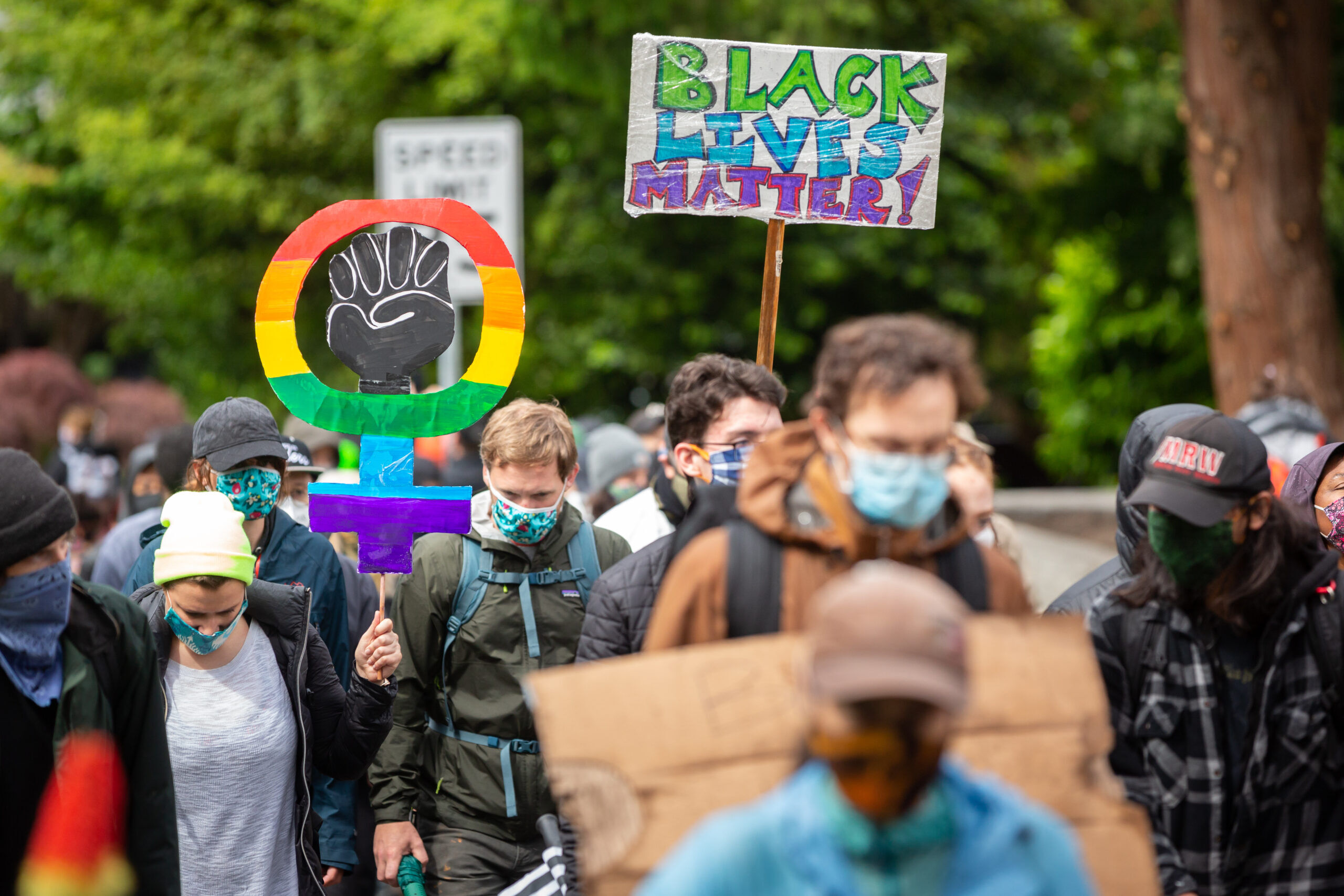 Protester with a rainbow BLM face mask raises a fist in solidarity during the "March of Silence" in Seattle on June 12, 2020