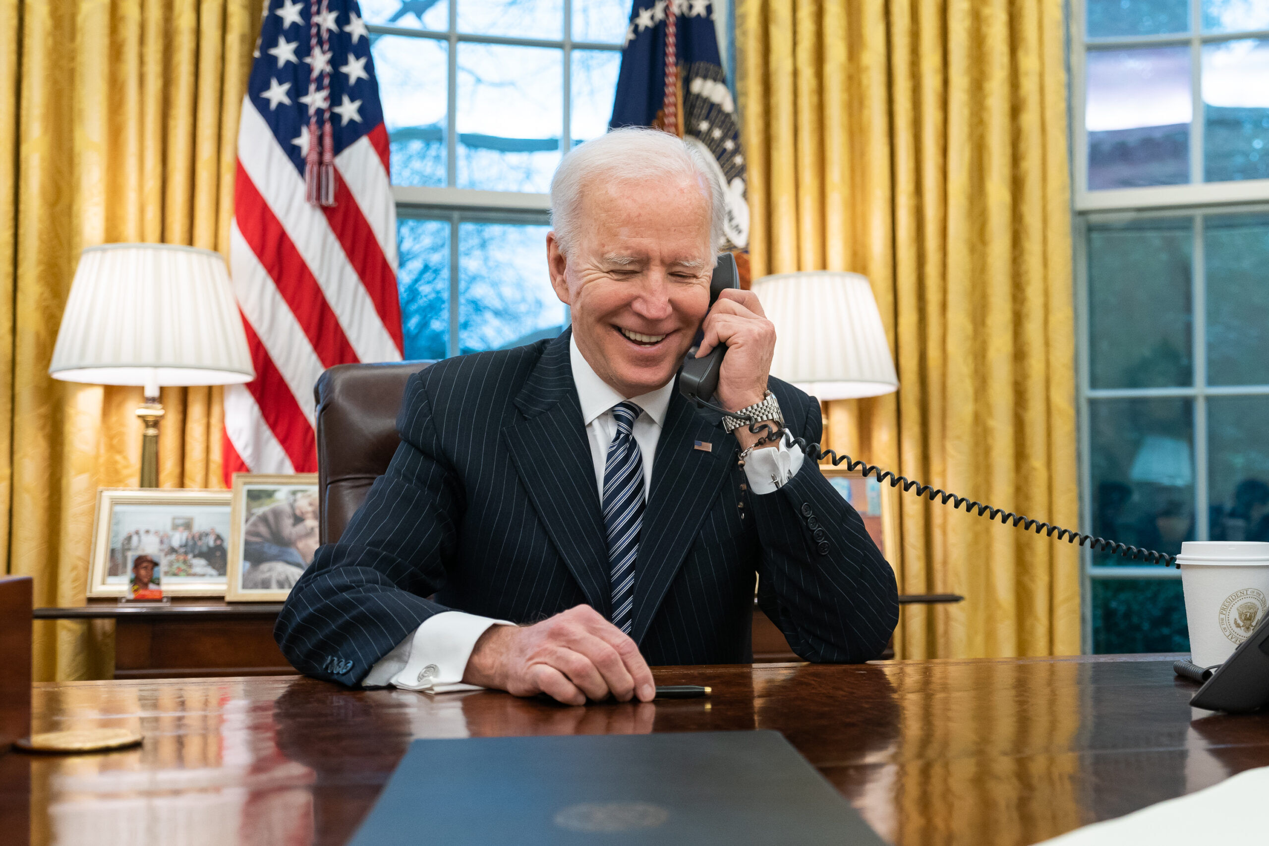 President Joe Biden talks on the phone with Katherine Tai in the Oval Office of the White House Thursday, March 18, 2021, to congratulate her on her confirmation as U.S. Trade Representative. (Official White House Photo by Adam Schultz)