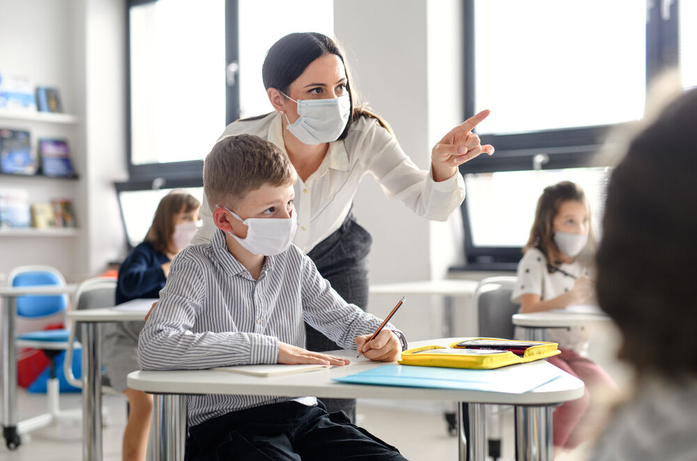 Teacher and a student with masks.