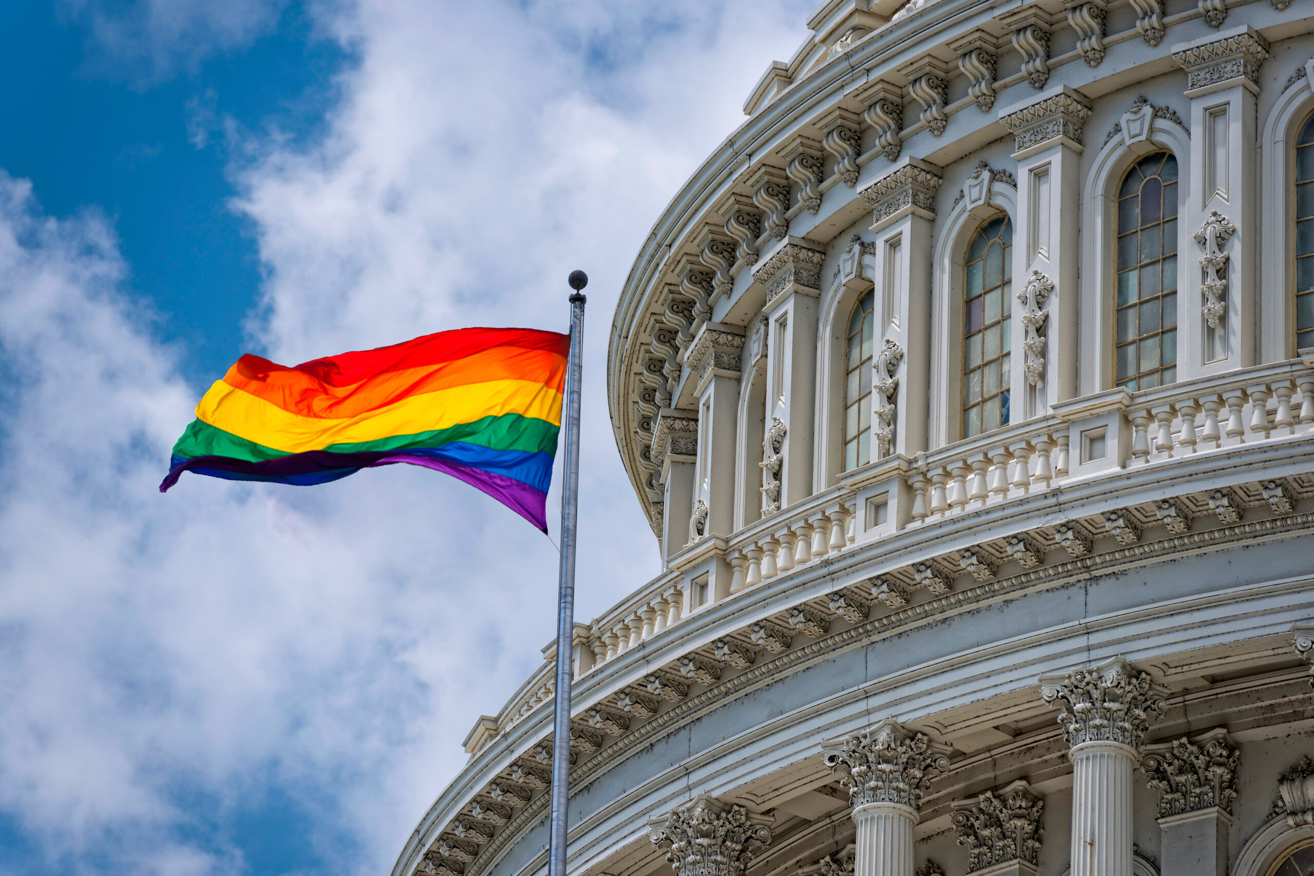 Washington DC Capitol dome detail with waving Rainbow flag