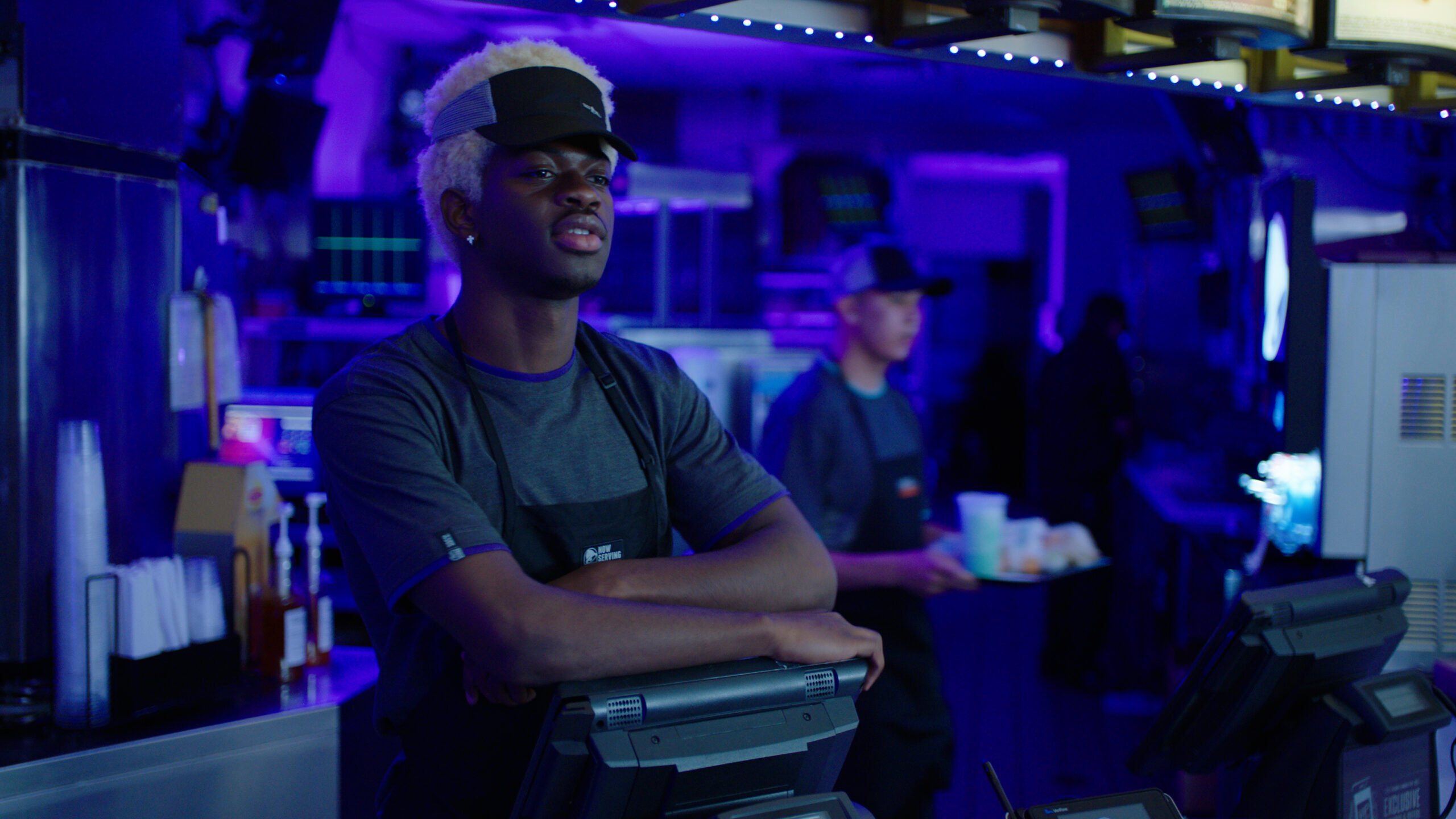 Lil Nas X portraying his teenage self, working at a Taco Bell in the music video "Sun Goes Down."
