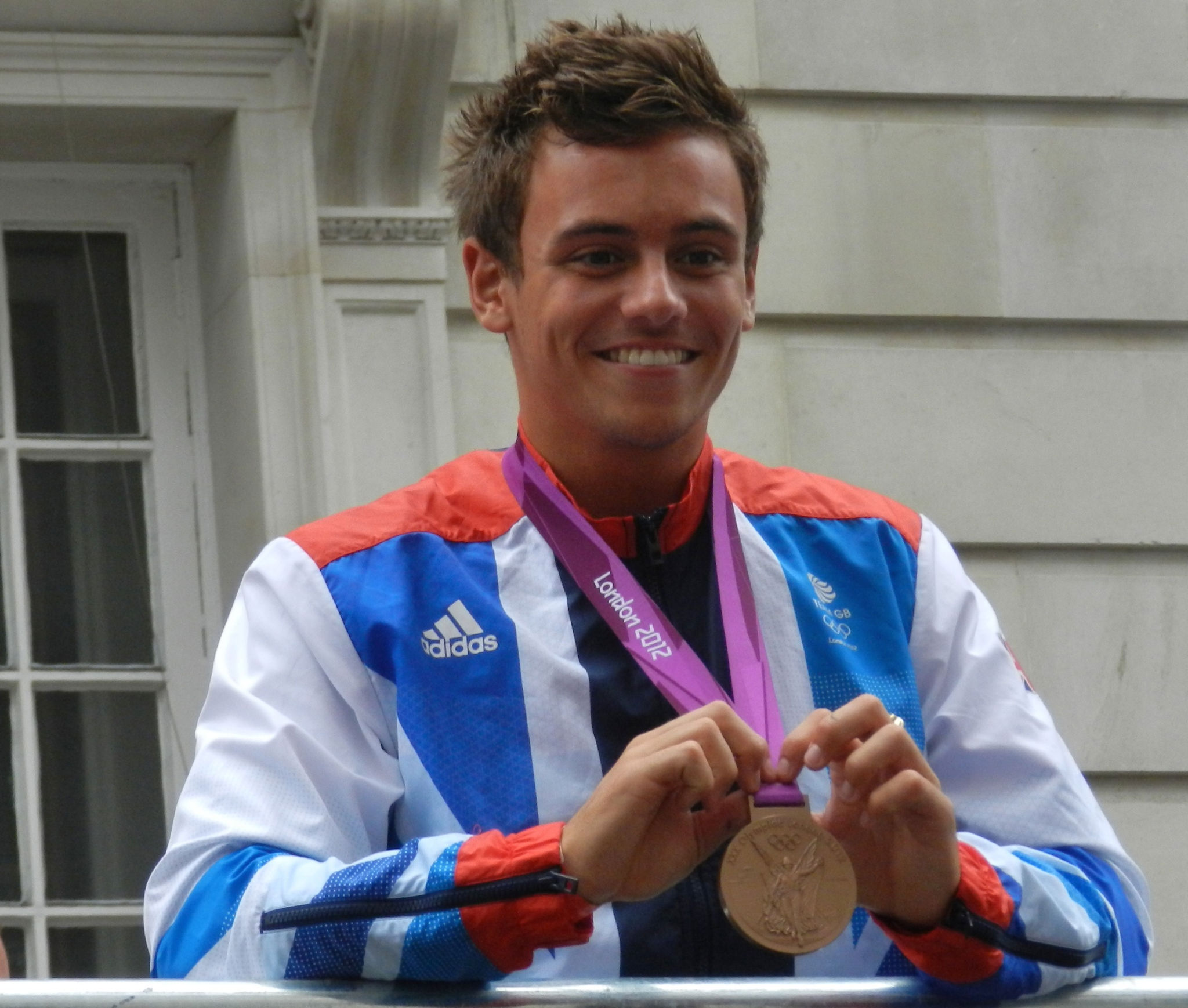 British Olympic diver Tom Daley at the 2012 Olympic Victory Parade holding his bronze medal