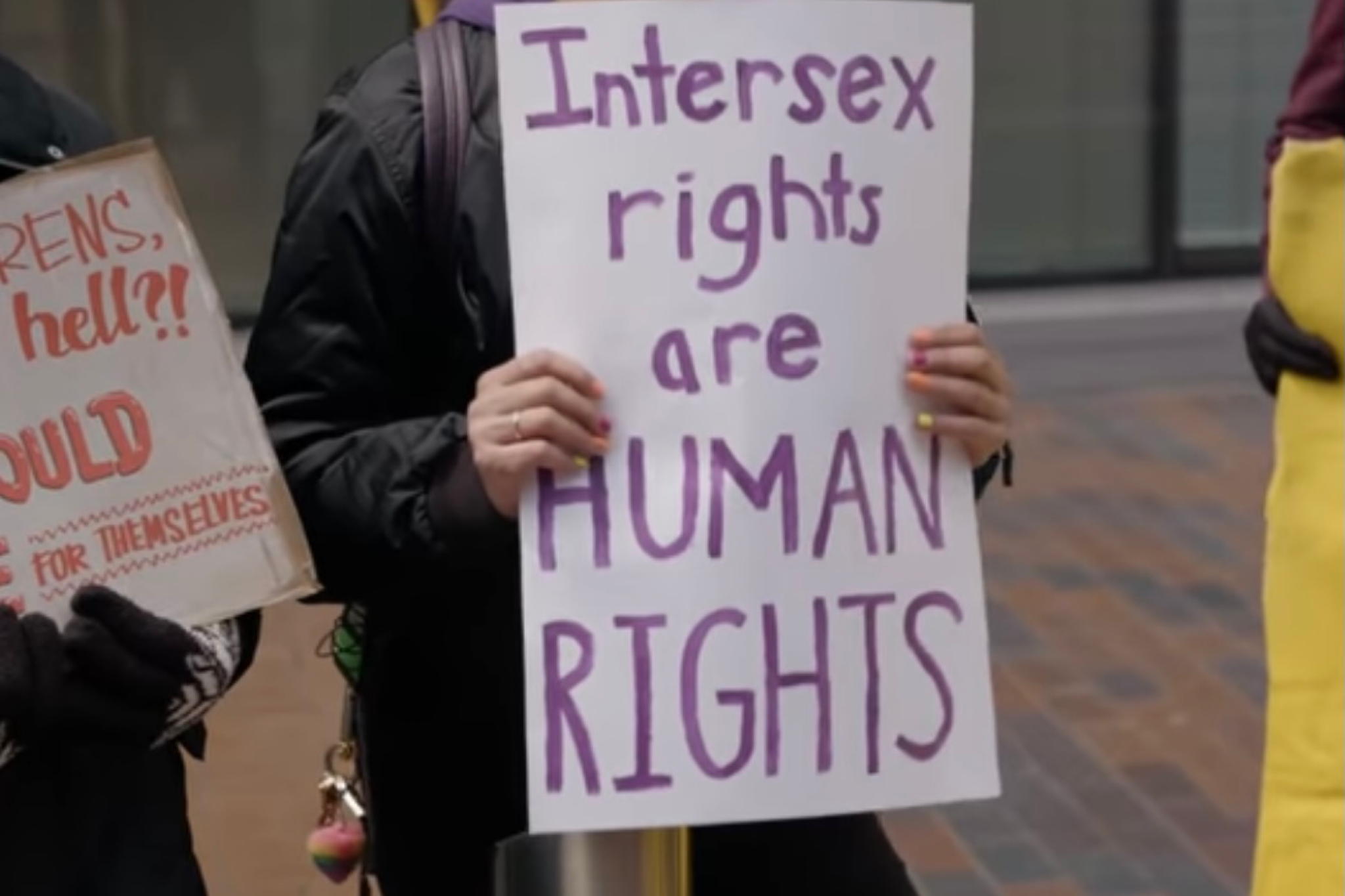A protestor holding a sign, advocating for intersex rights outside a hospital in Chicago in 2019.