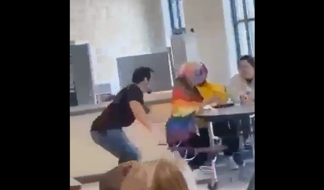 A student a Lowndes High School in Valdosta, GA assaults another teen who is wrapped in a rainbow Pride flag.