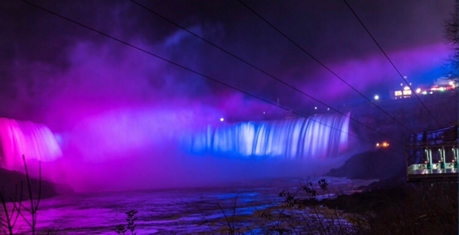 Niagara Falls lit in the colors of the Bisexual Pride Flag