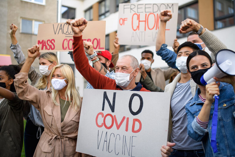 People,With,Placards,And,Posters,On,Public,Demonstration,,No,Covid anti-vaxxers, anti-maskers, vaccination sites, threats, arson, protests, schools, children