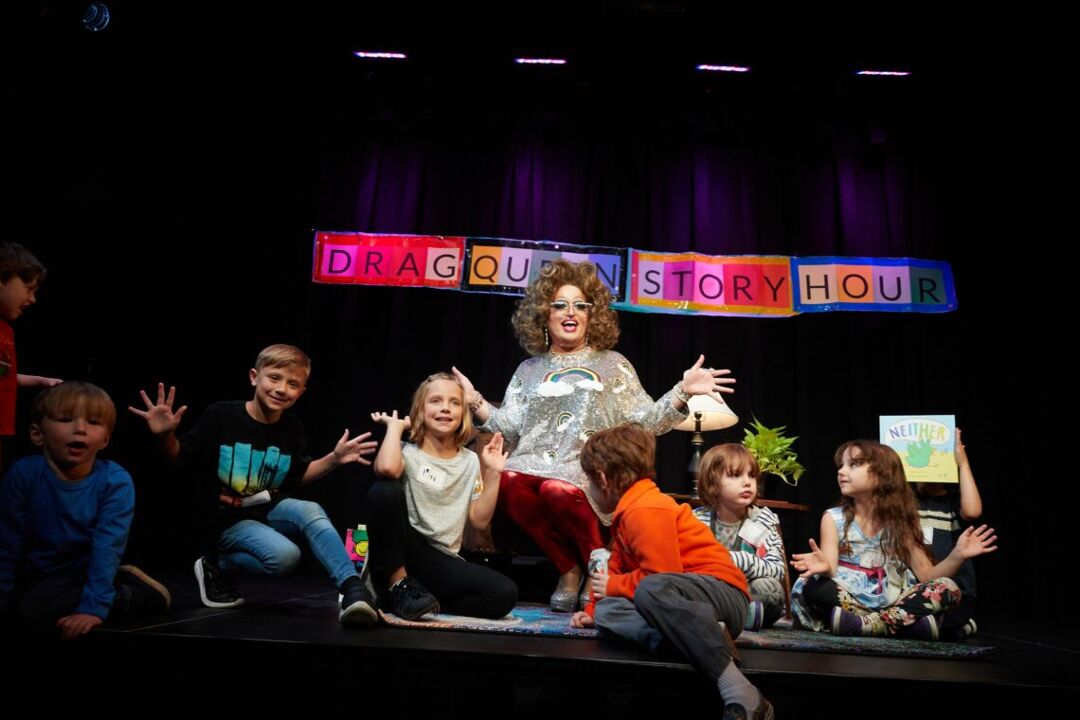 Little Miss Hot Mess reads to children at a Drag Queen Story Hour event.