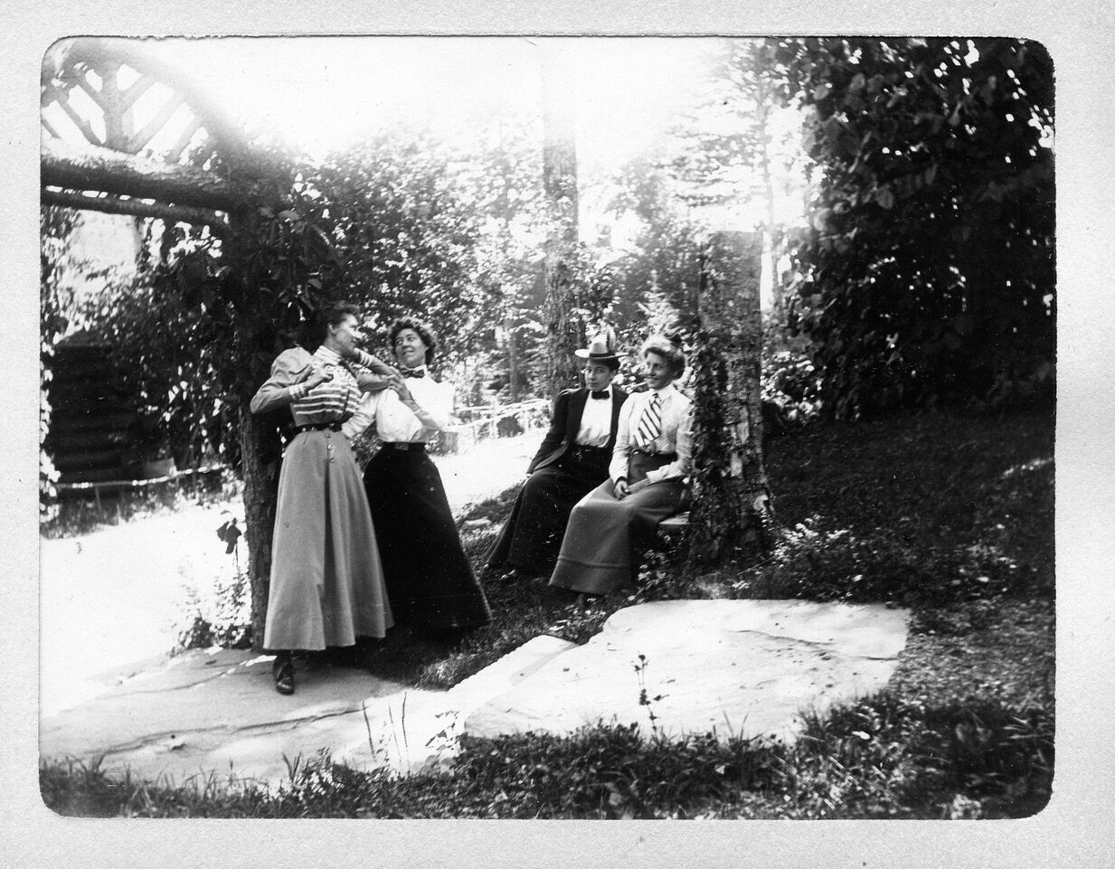Gertrude Tate, second from left wearing white shirt and bow tie, and Alice Austen, third from left, seated, wearing white shirt and bow tie, enjoyed a trip to the Catskills in 1899. Austen made the photo album for Tate.