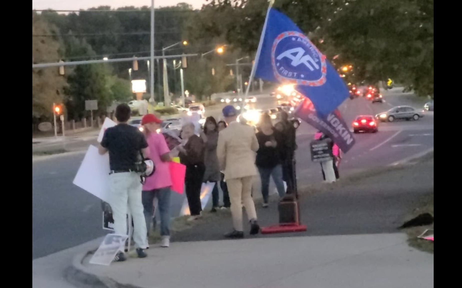 White nationalists carrying an "America First" and "Youngkin for Governor" flags outside a school board meeting on October 21, 2021 in Fairfax, VA