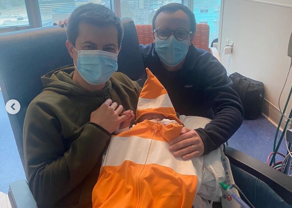 Pete and Chasten Buttigieg hold their son, Gus, during his hospital stay.