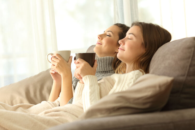 Lesbian couple relaxing on couch