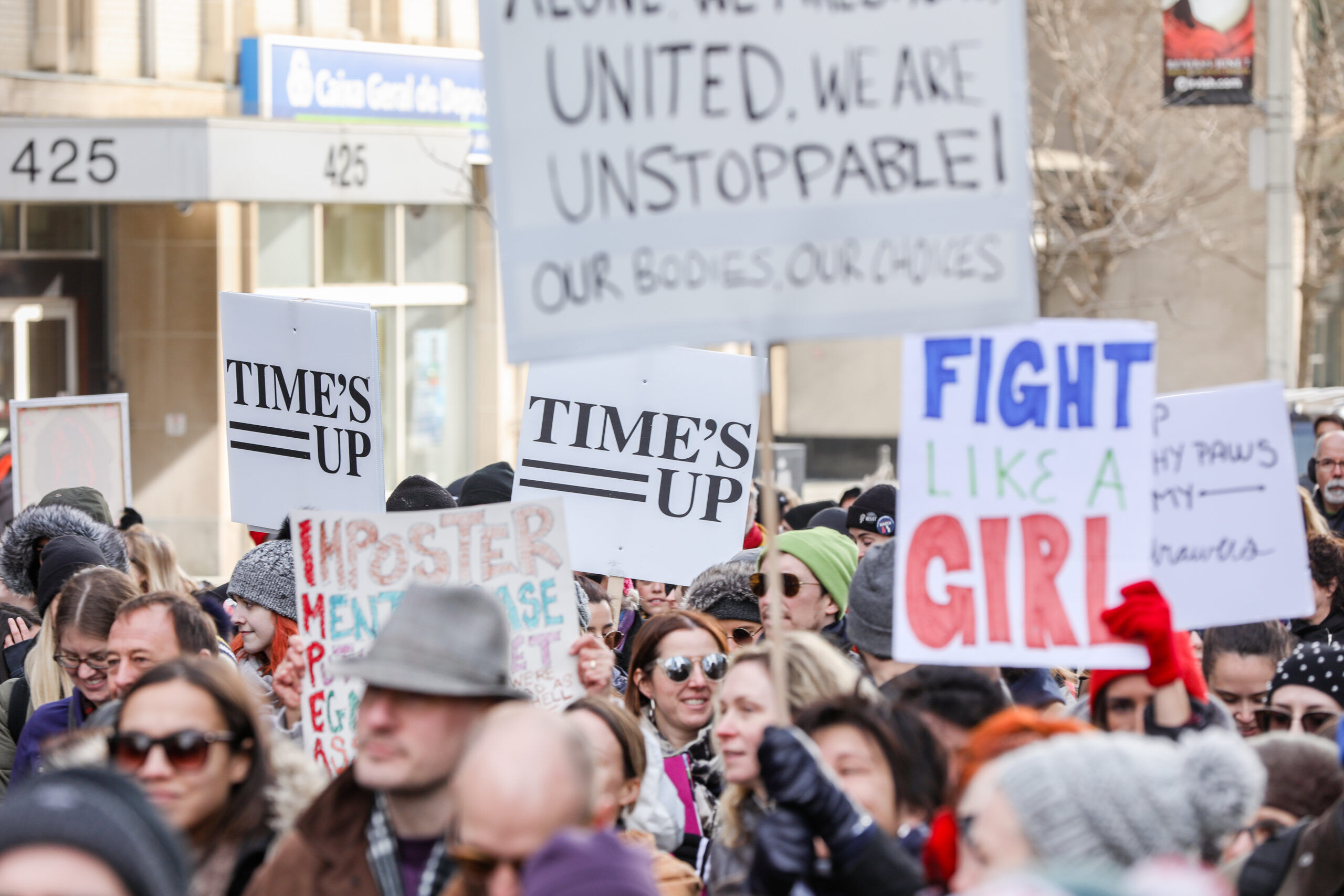 TORONTO, CANADA - JANUARY 20, 2018: PROTESTERS WITH SIGNS AT WOMEN'S MARCH ON TORONTO: DEFINING OUR FUTURE.