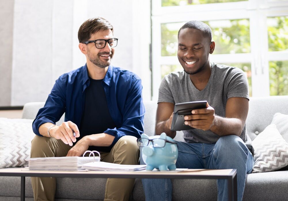 Gay couple doing taxes. they're happy, maybe because of the new tax break from Joe Biden