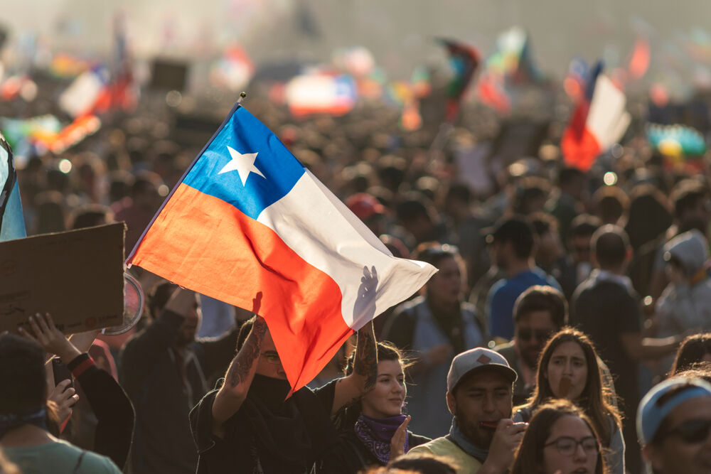 Santiago Chile 29 October 2019: Crowds protesting at Santiago de Chile streets in Plaza de Italia during protests and general strike. Police repelled the crowd with tear gas.