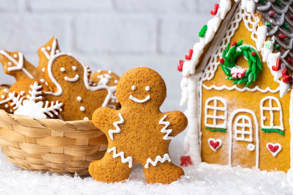 Gingerbread people outside their gingerbread house