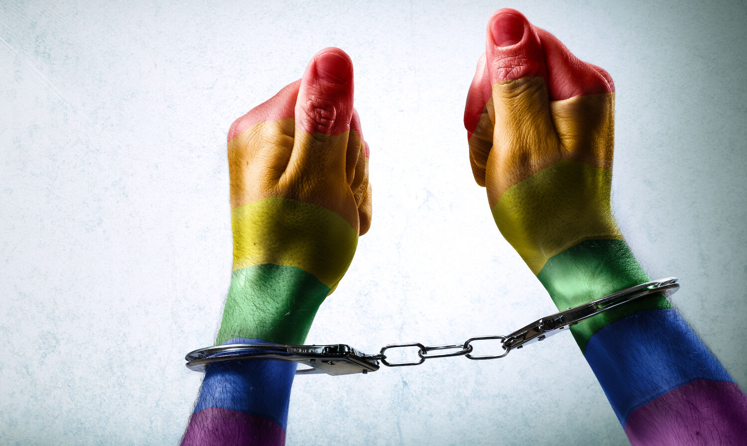 Rainbow hands in handcuffs