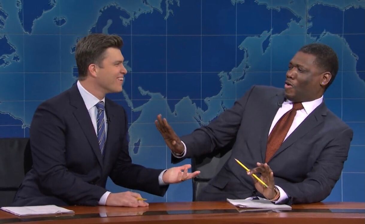 Colin Jost goes in to kiss Michael Che on SNL's "Weekend Update"