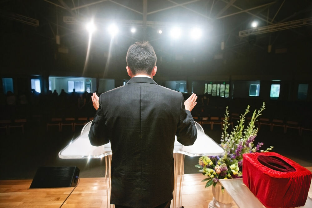 A pastor preaching before a congregation
