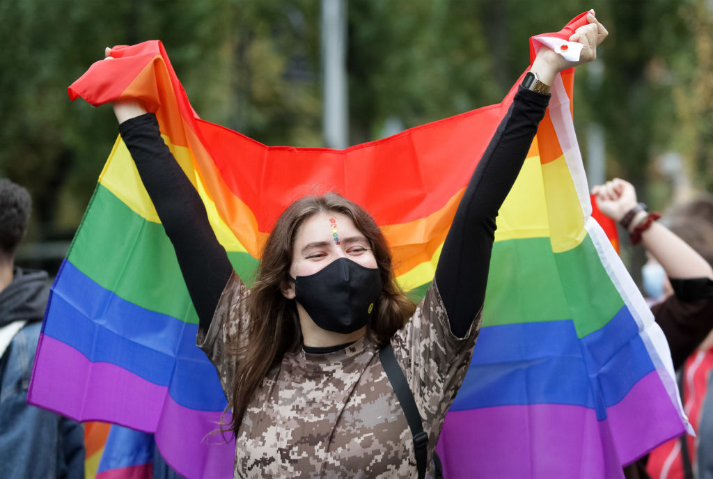 KYIV, UKRAINE - 2021/09/19: A woman wearing a face mask carries a rainbow flag during the Equality March KyivPride 2021 of the LGBT community. Thousands of participants turned up in Kiev for the annual Gay Pride parade or March of Equality.