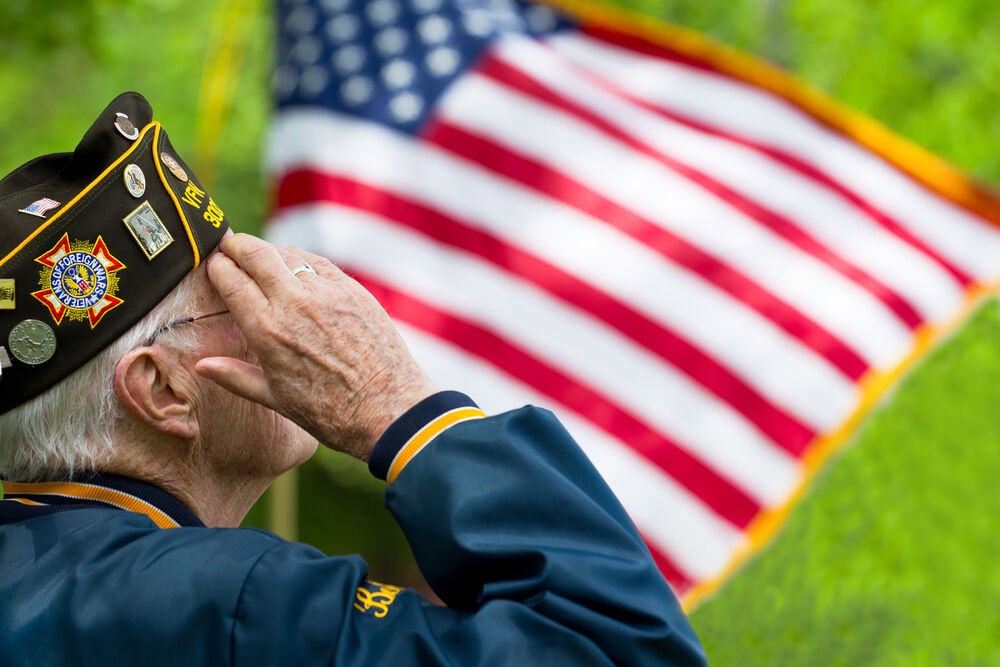 A veteran salutes the flag